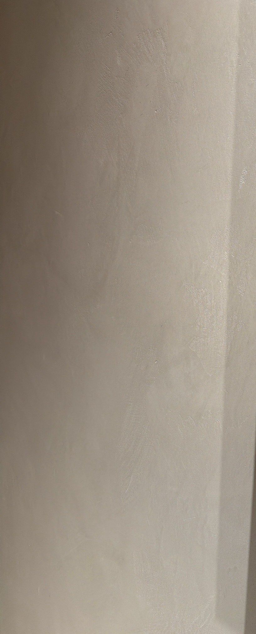 Warm white Venetian plaster in sunlight